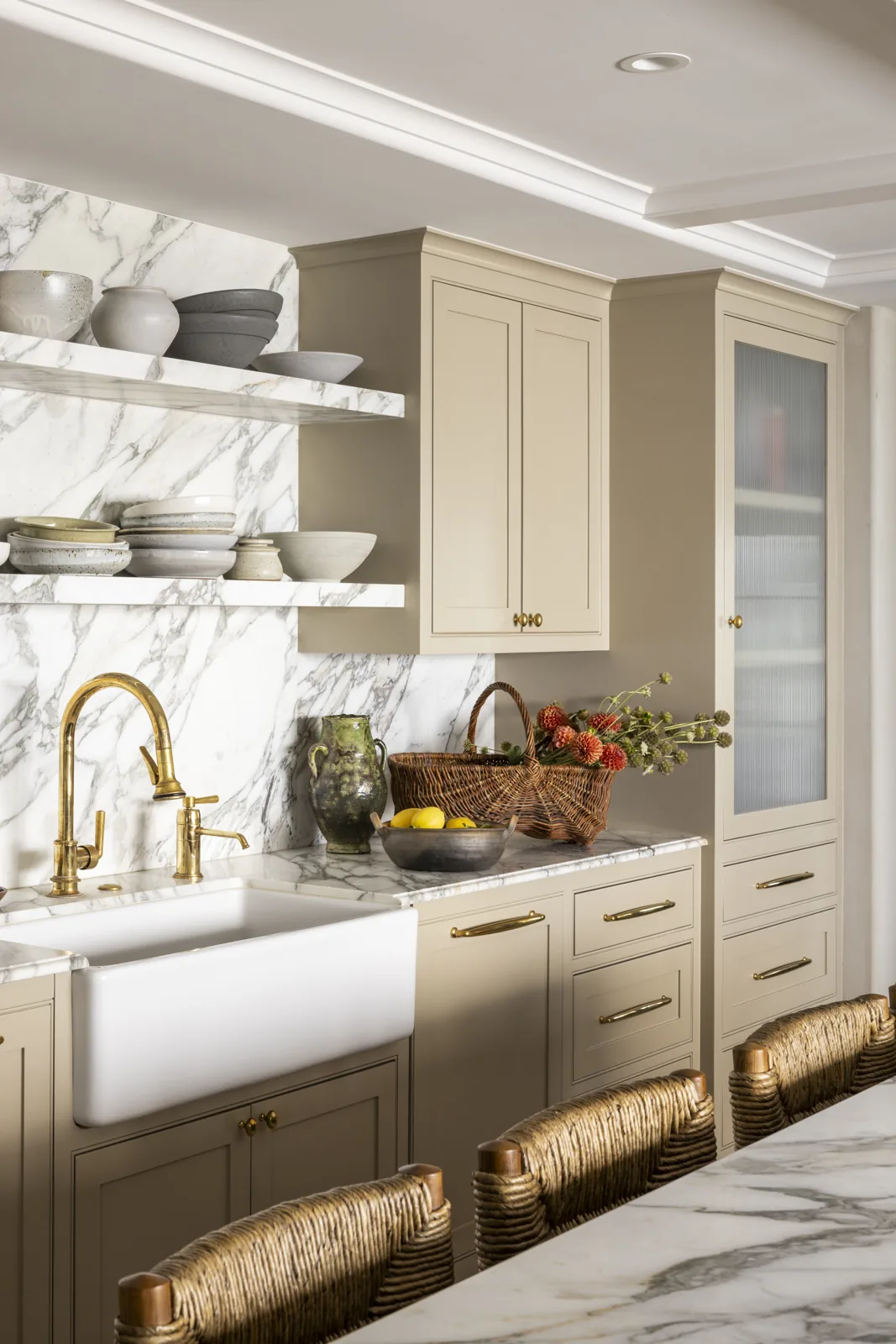 Farmhouse sink with brass fixtures, marble shelving, and painted cabinetry at Adobe Canyon Farmhouse