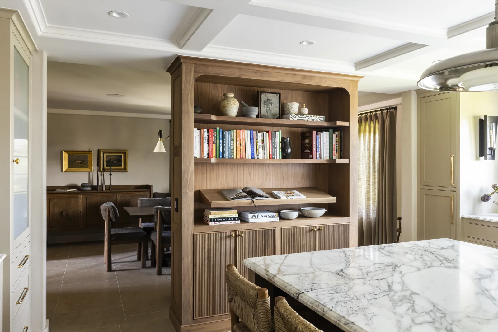 Kitchen island and custom wood shelving with views into the dining area at Adobe Canyon Farmhouse