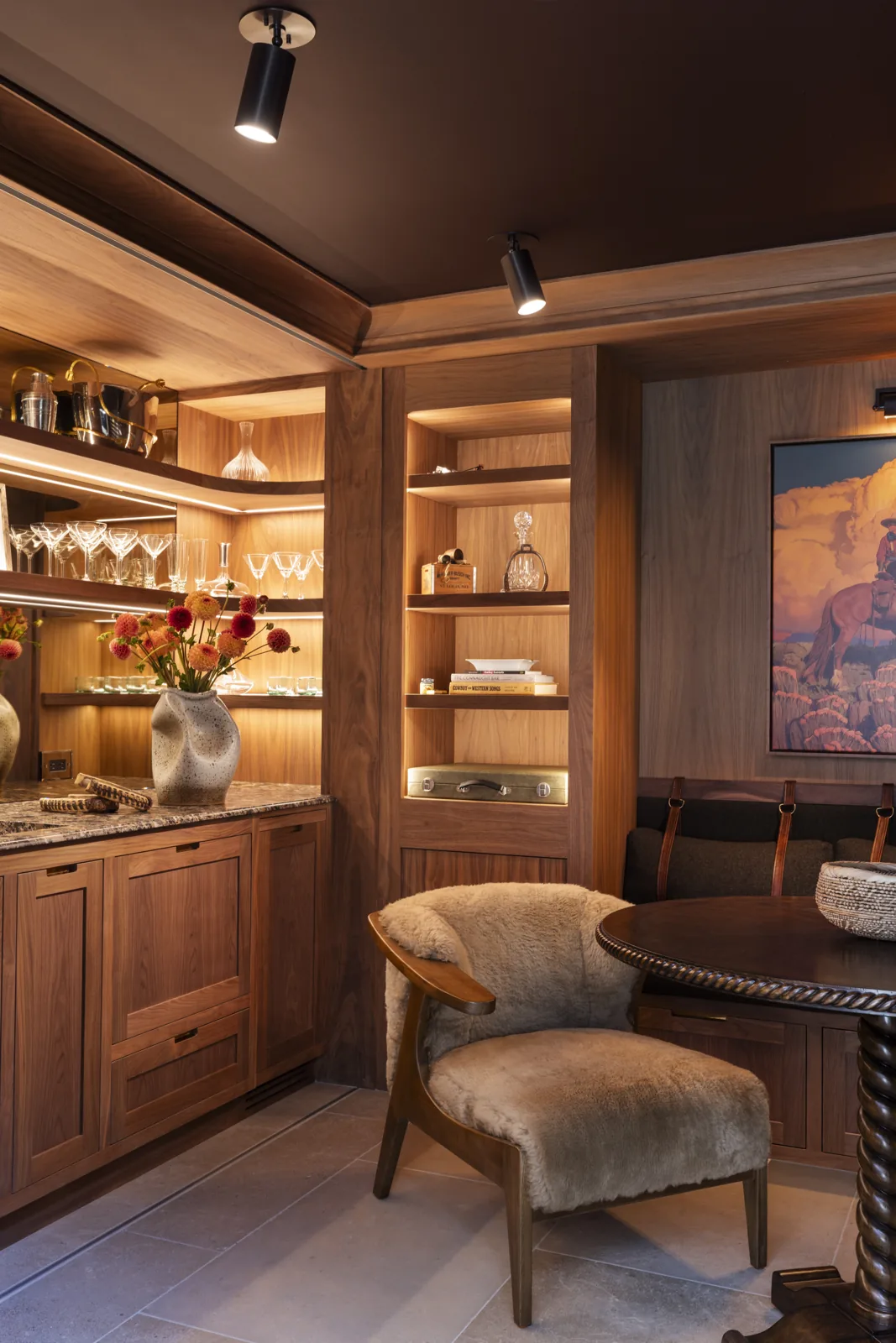 Custom wood bar and sitting nook with illuminated shelves and upholstered seating at Adobe Canyon Farmhouse