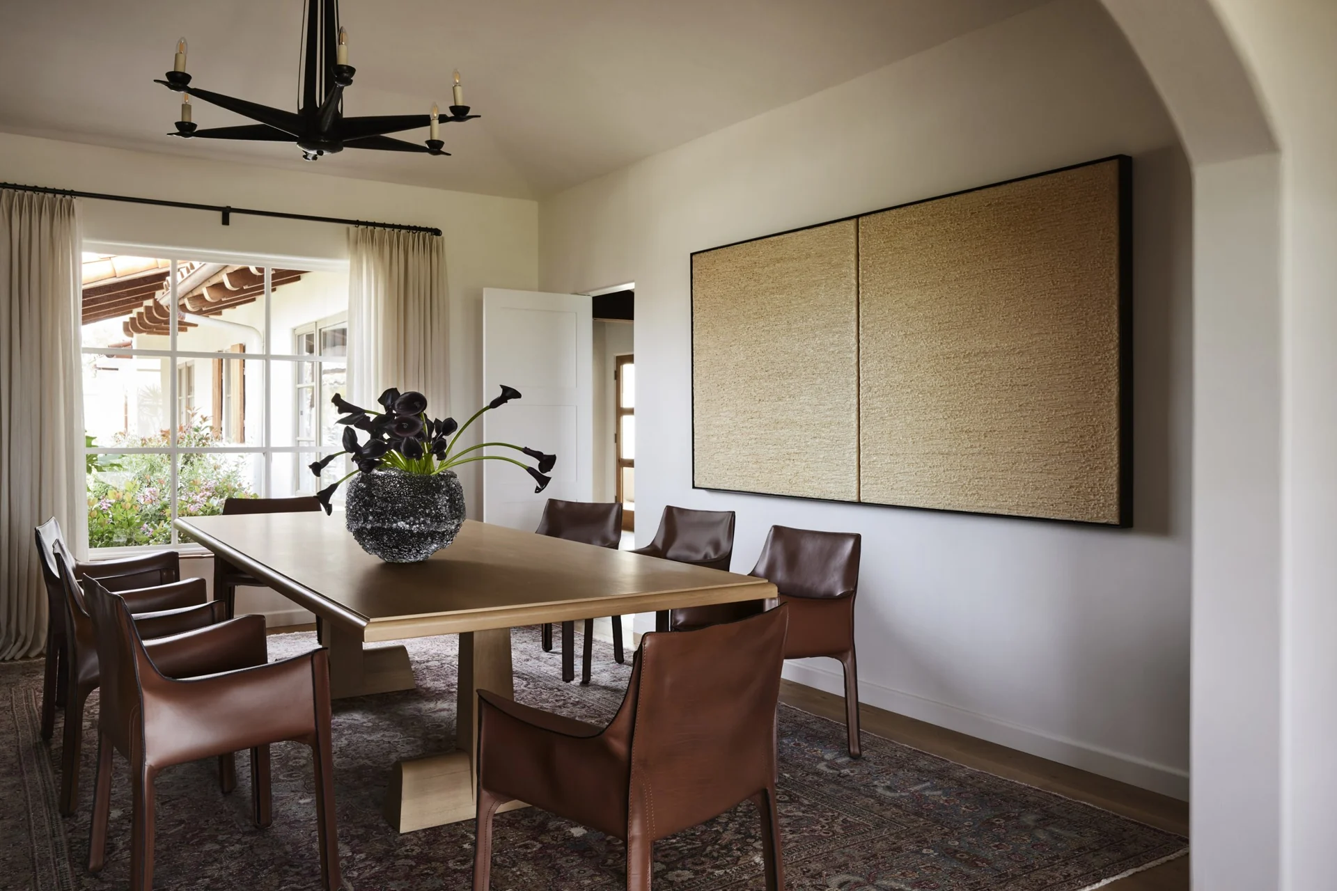 Dining room with leather chairs and garden views