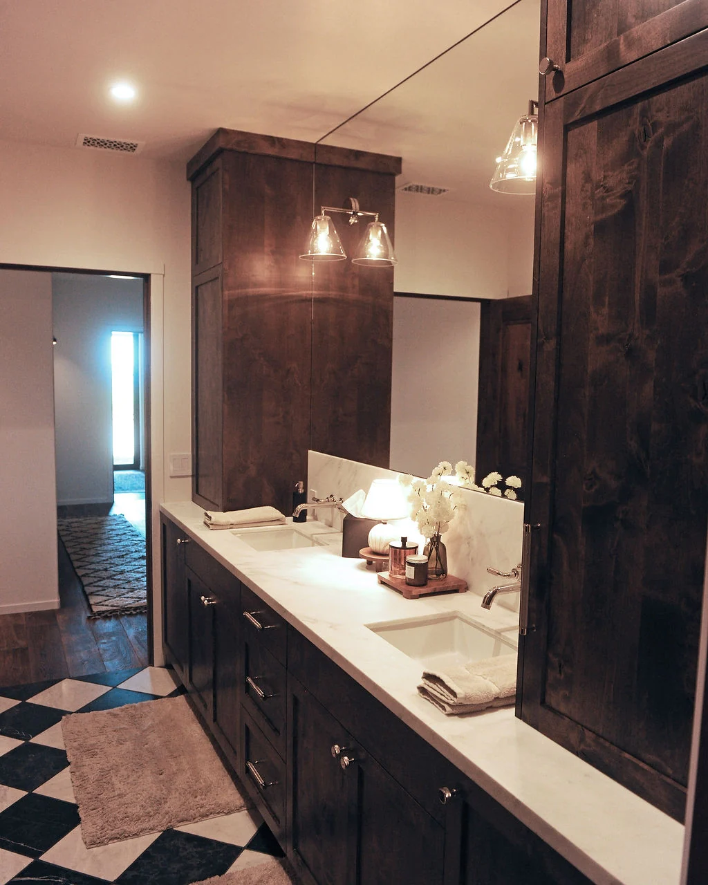 Bathroom with dark wood cabinetry and pale stone counters