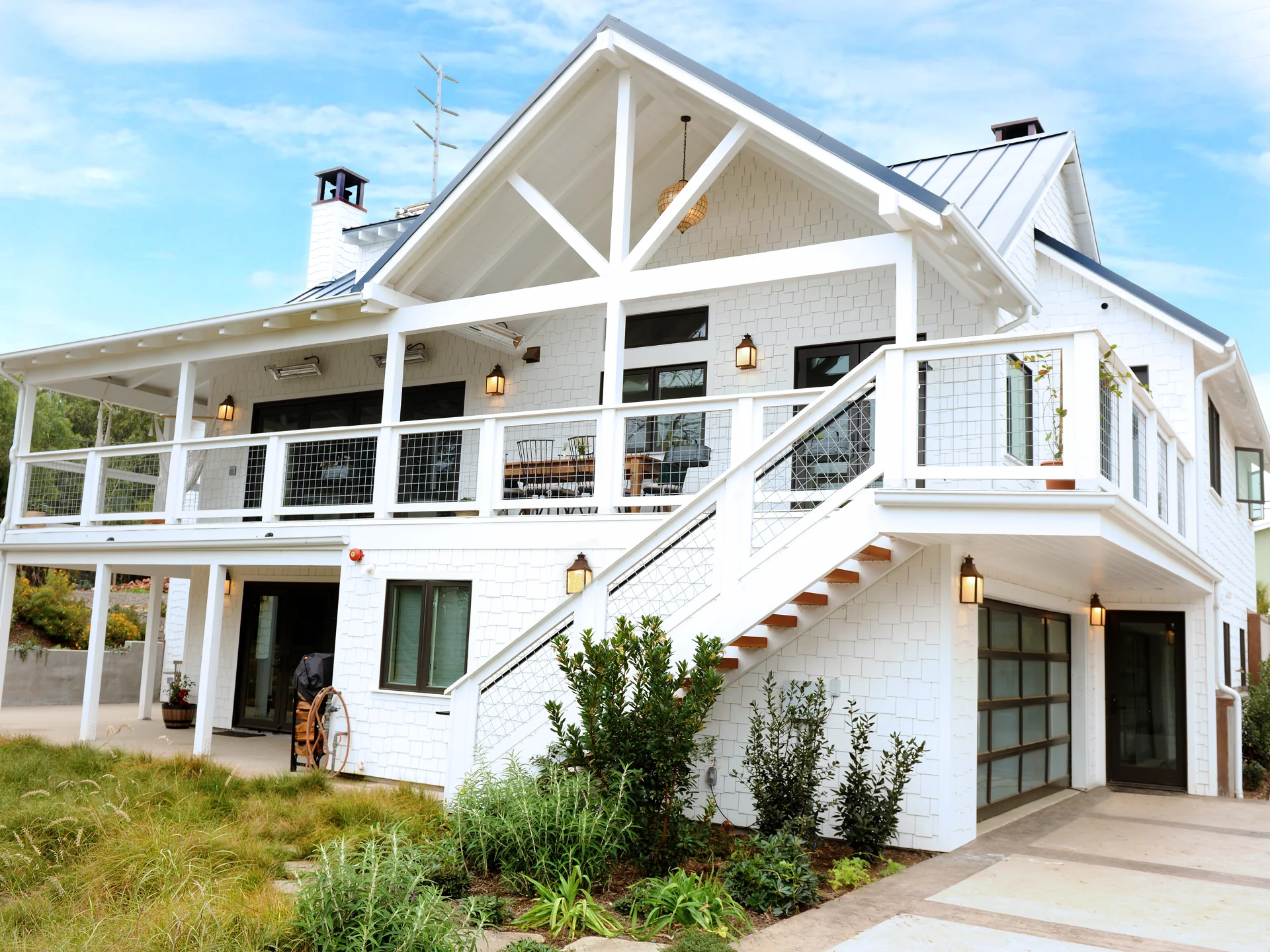 French Country In Goleta rear exterior with a covered terrace and garden