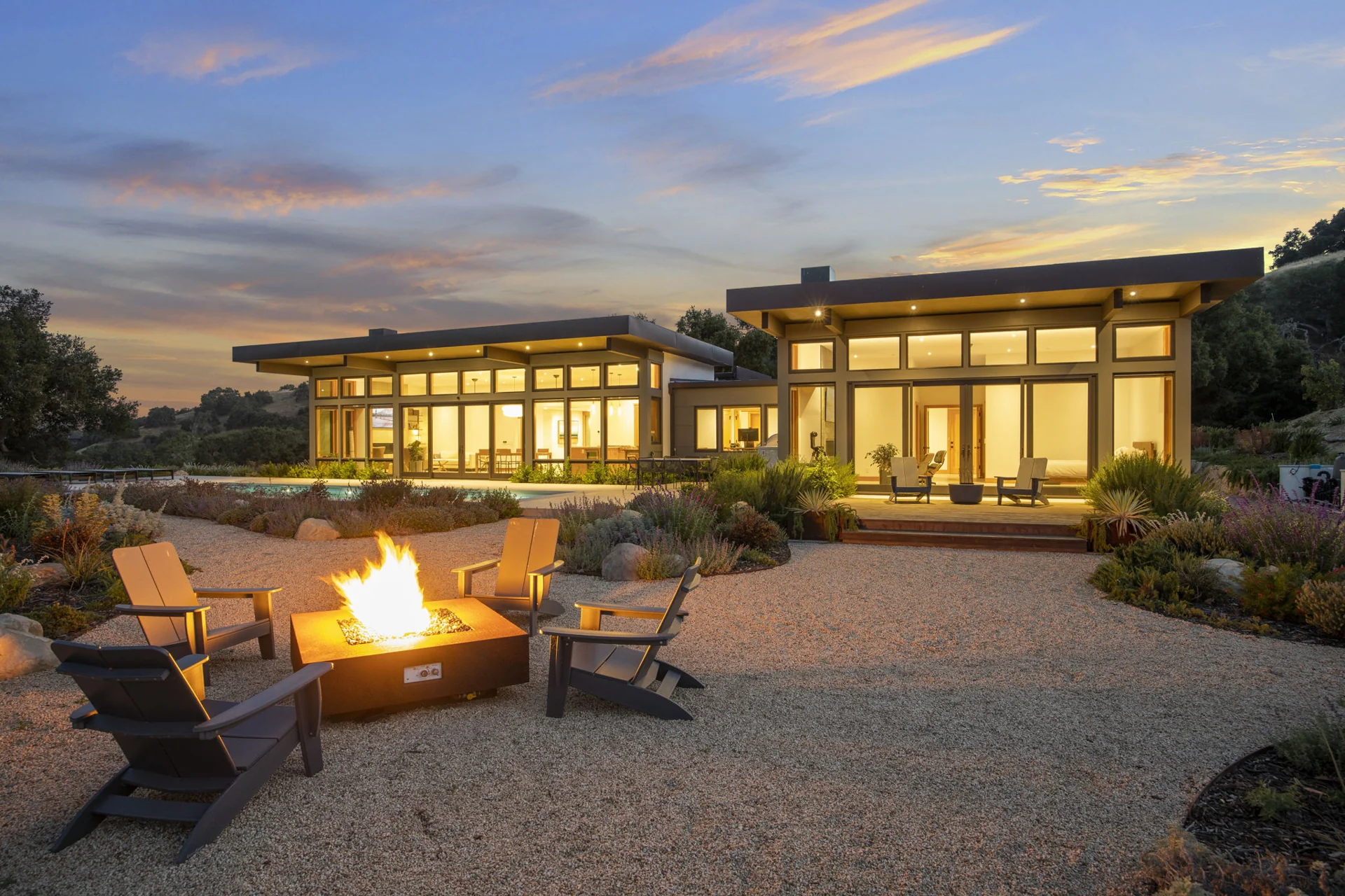 Retreat exterior and outdoor fire pit at dusk