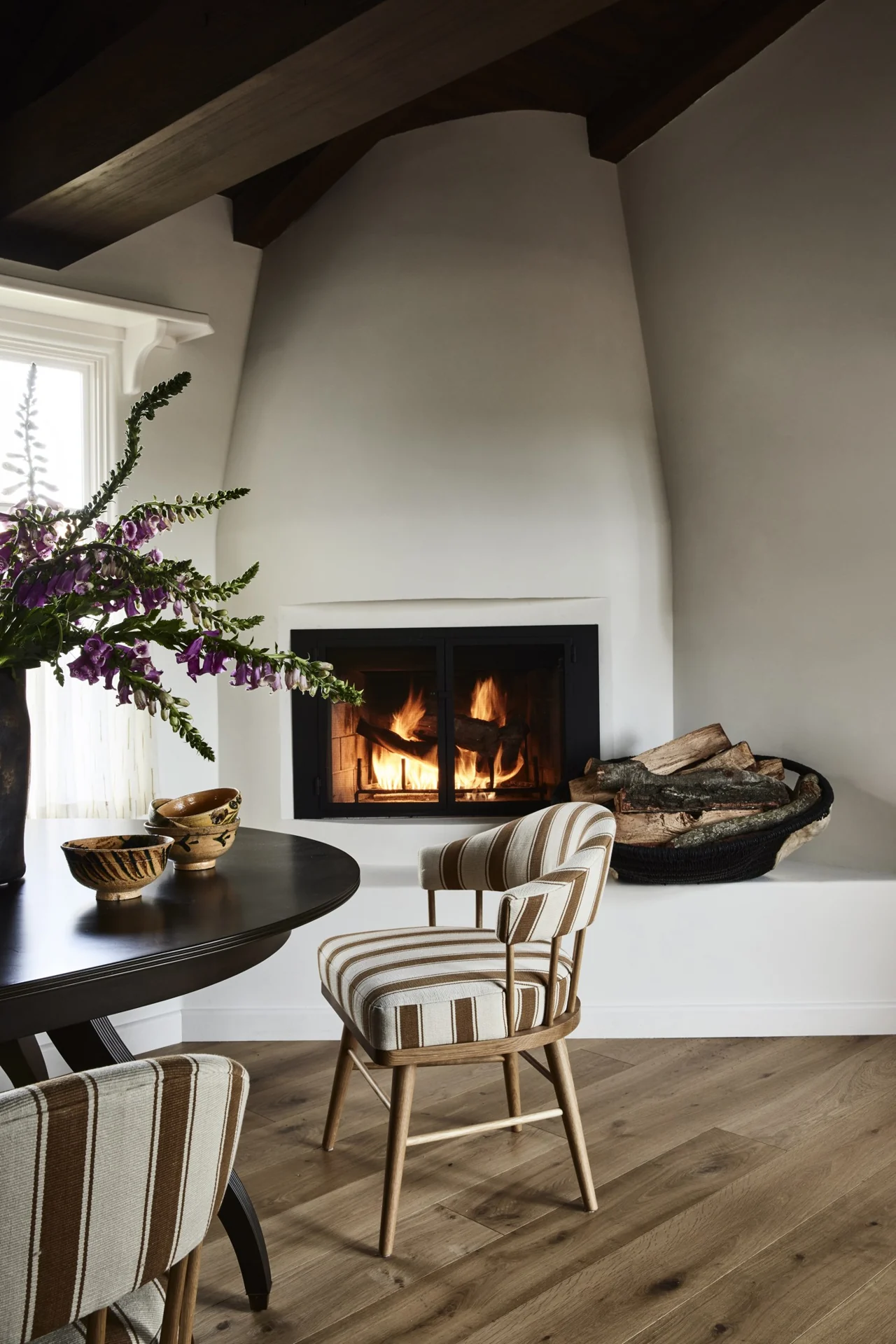 Dining nook beside a sculpted fireplace