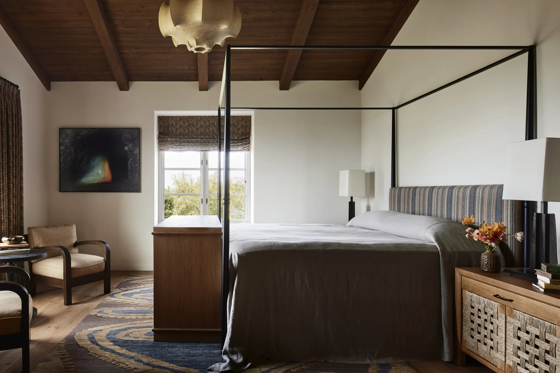 Bedroom with a canopy bed and exposed timber ceiling