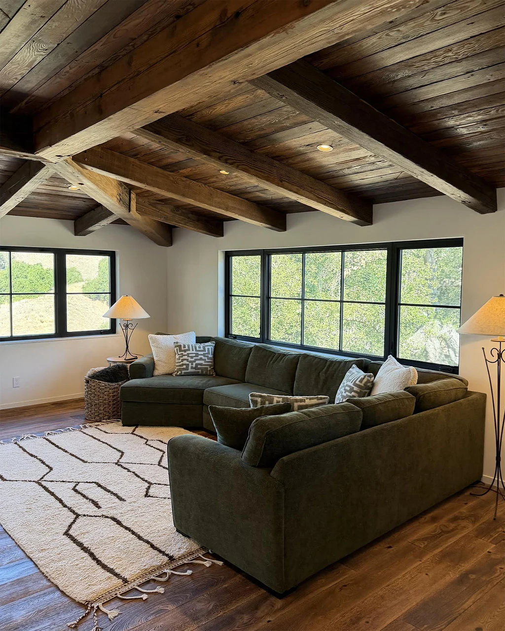 Family room with timber ceiling and green sectional sofa