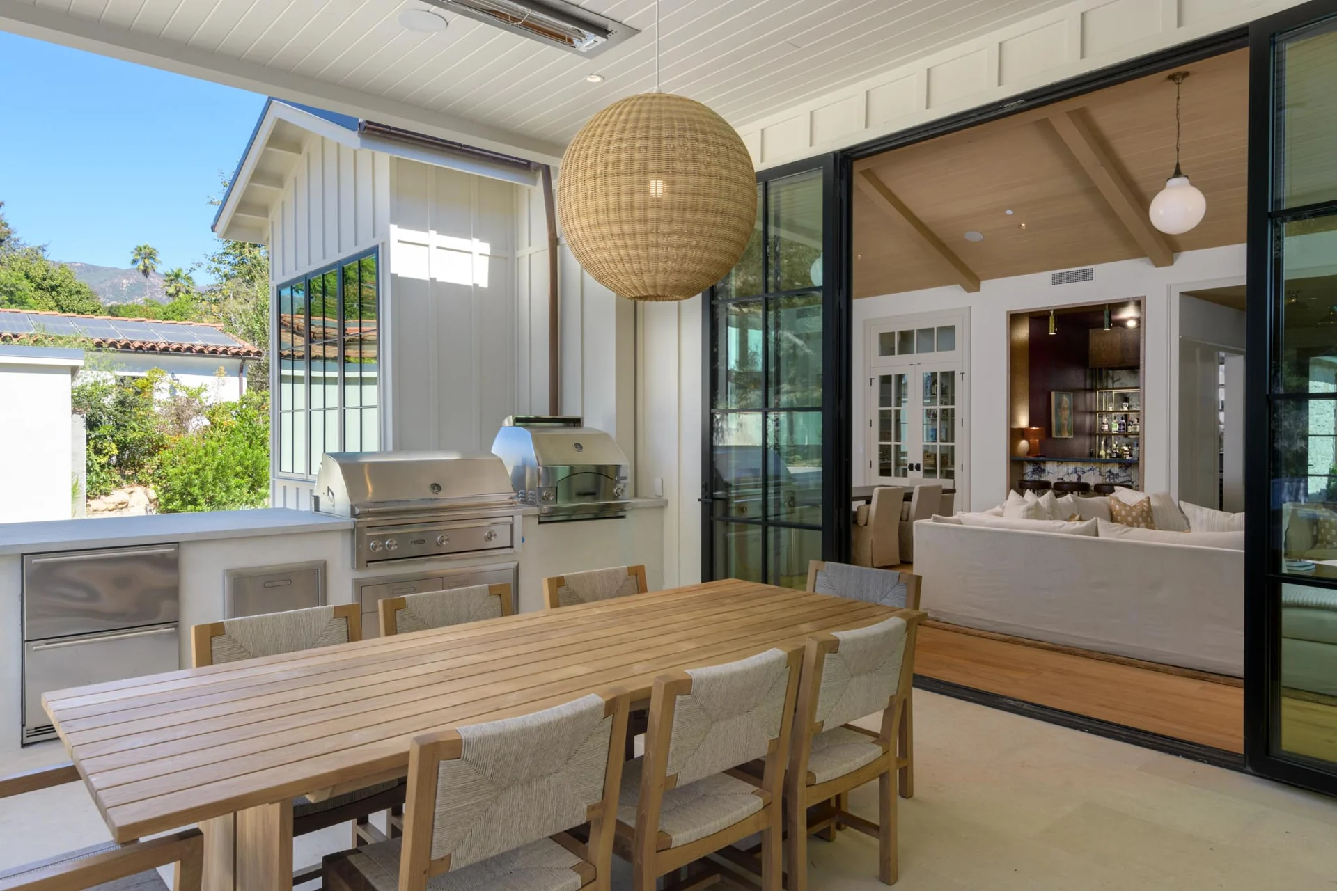 Covered outdoor dining terrace with an outdoor kitchen