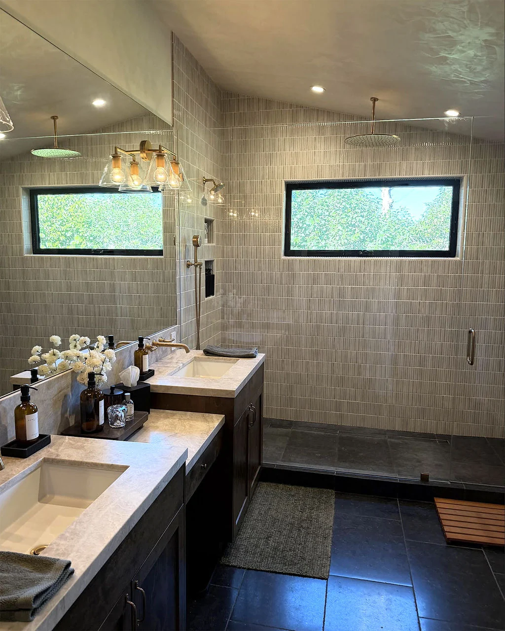Bathroom with double vanity and glass-enclosed shower