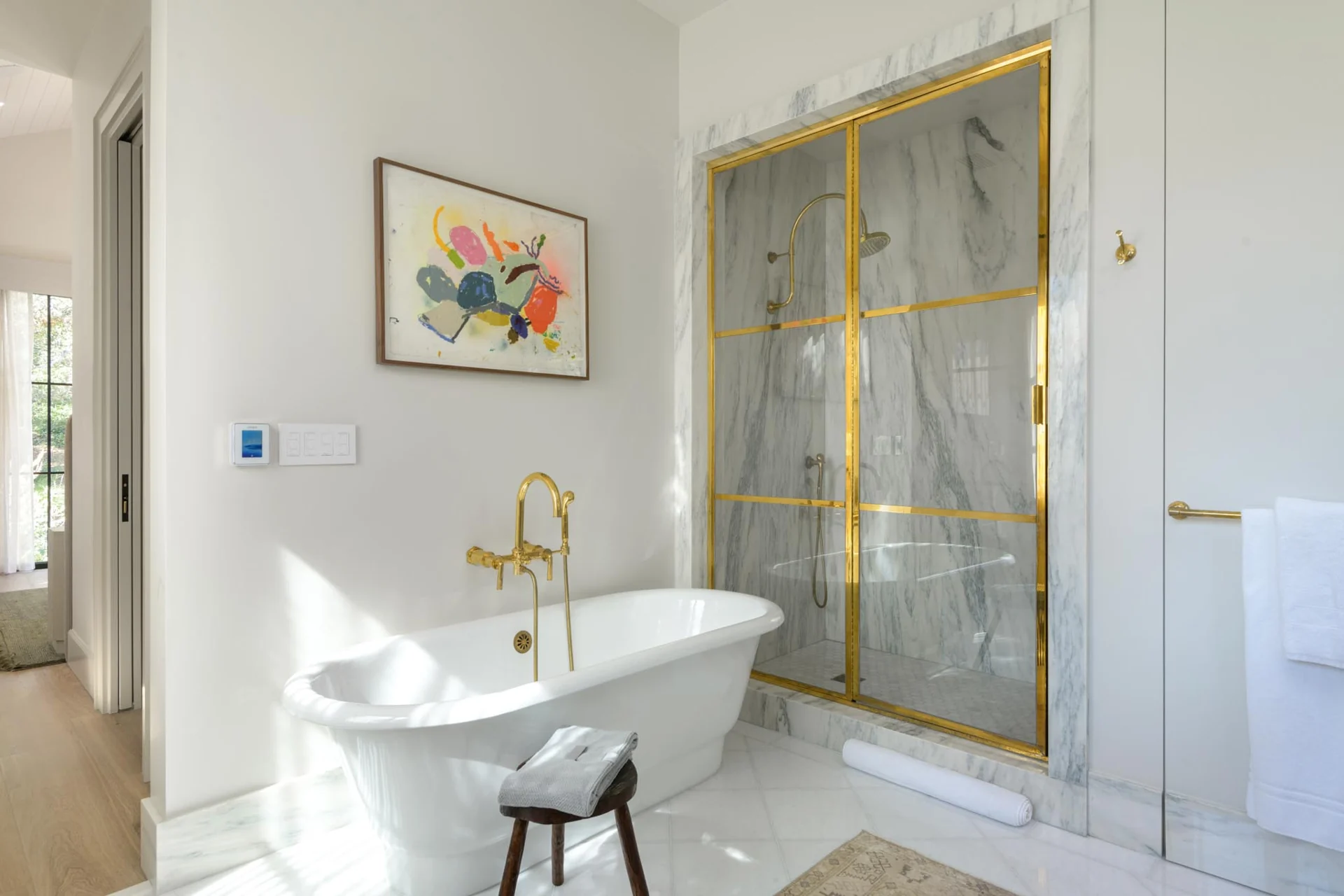 Bathroom with a freestanding bathtub and marble shower