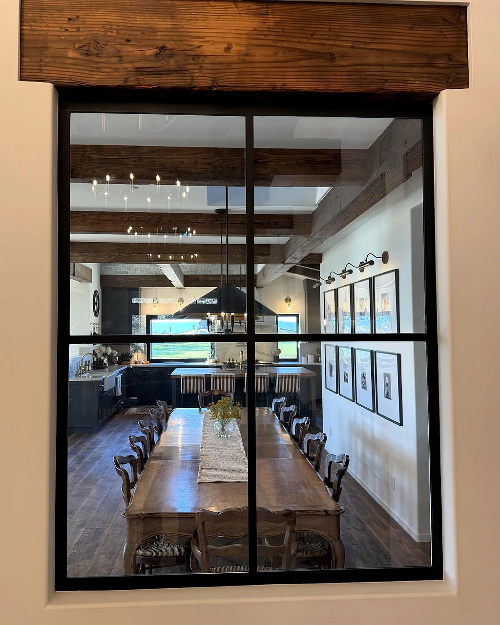Dining room and kitchen viewed through an interior window