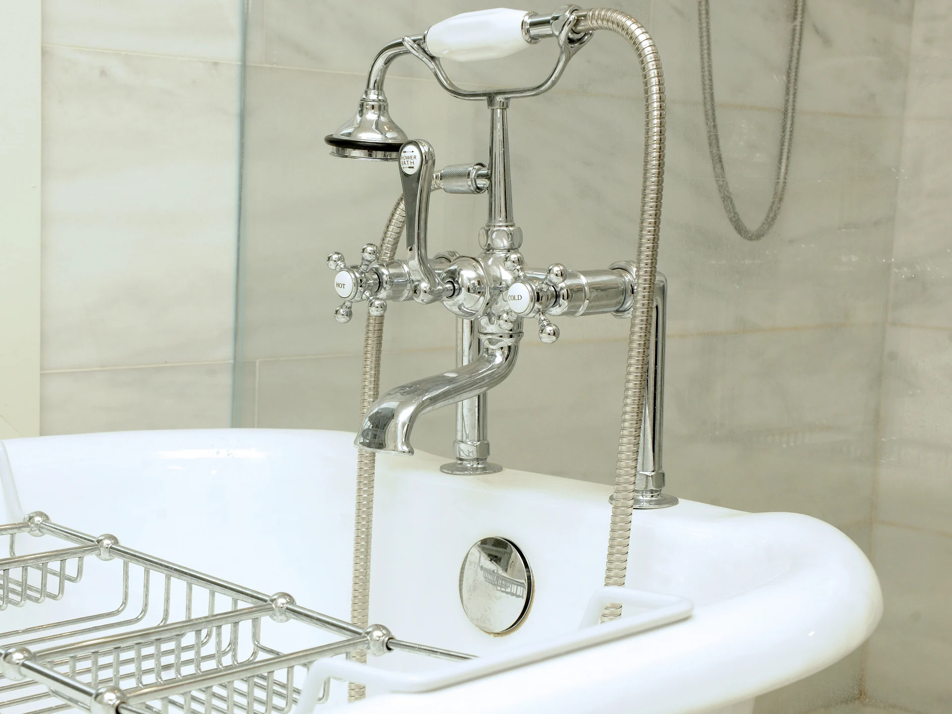 Freestanding bathtub with traditional chrome fixtures at French Country In Goleta