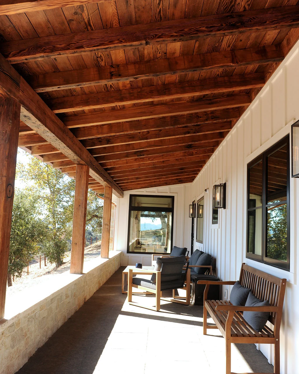 Covered porch with timber ceiling and outdoor seating