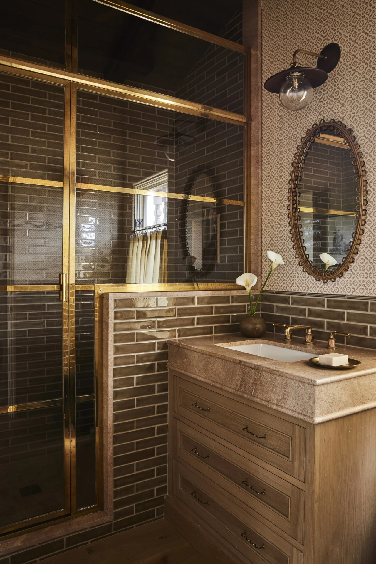 Bathroom with bronze-toned shower frame and stone vanity