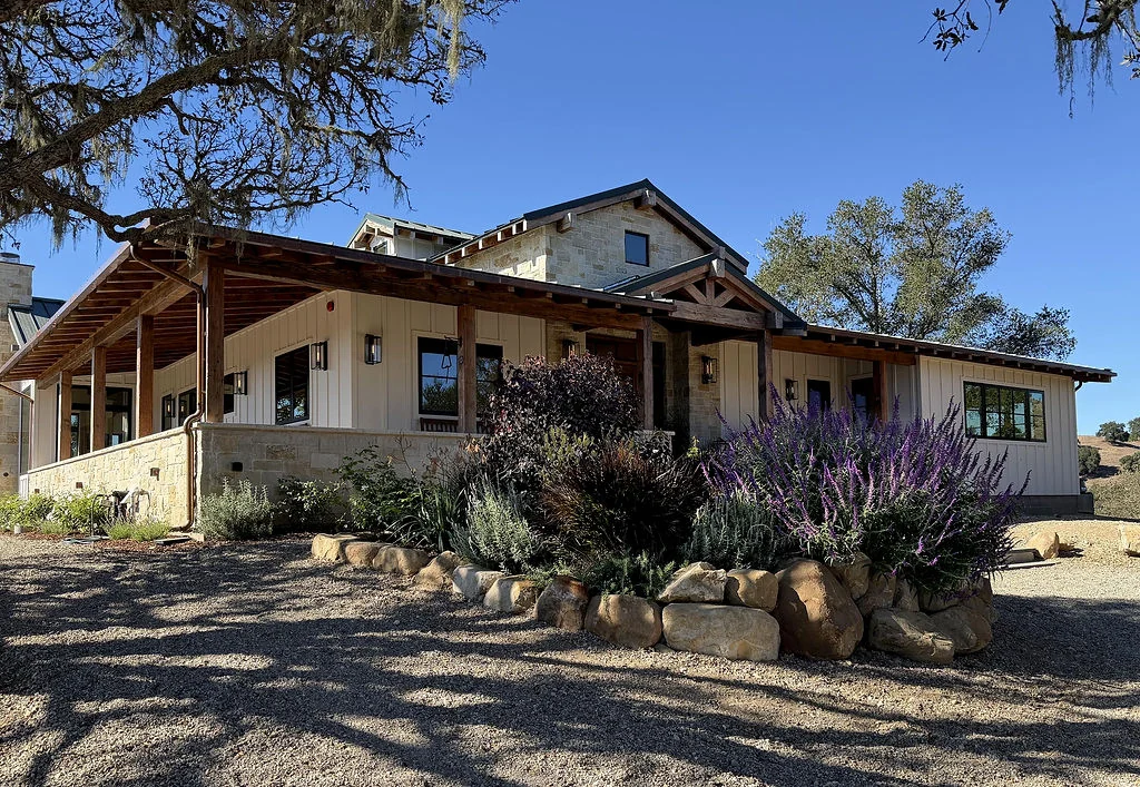 17 Acre Ranch exterior with timber porch, stonework, and landscaping